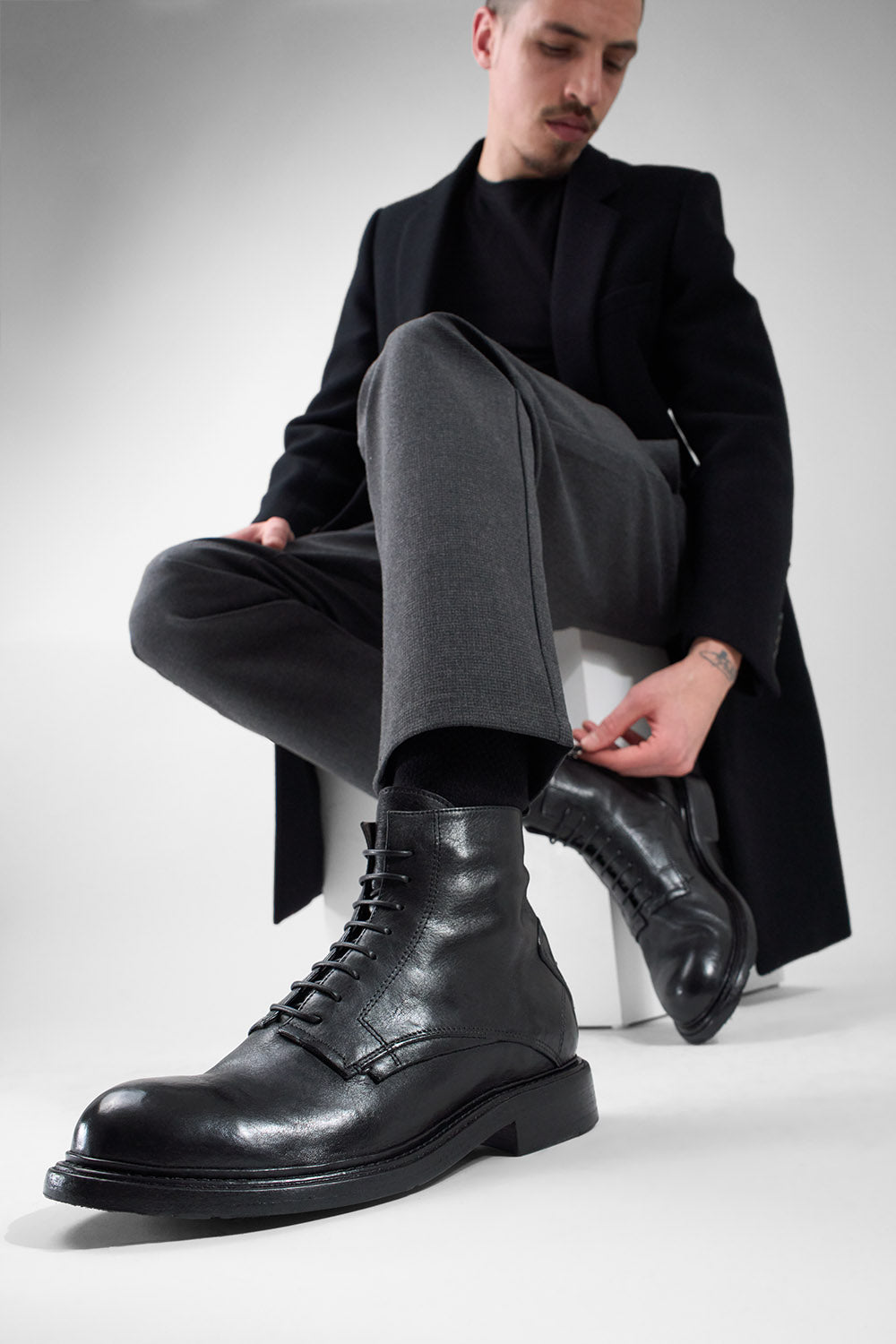 BOLTON limo-black layered lace up boots.