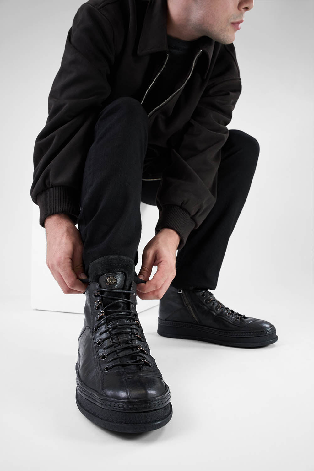 COLE urban-black asymmetric welted high sneakers.