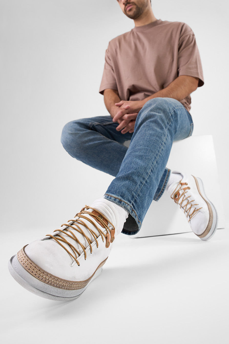 COLE white welted distressed loop sneakers.