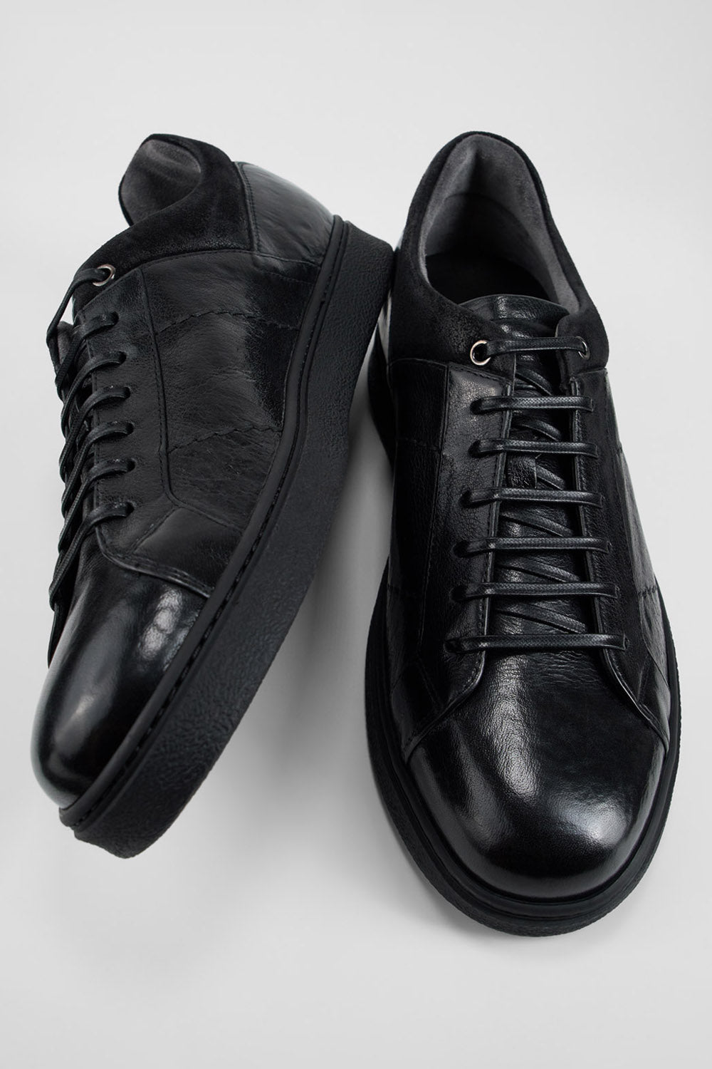 CREED jet-black distressed sneakers.