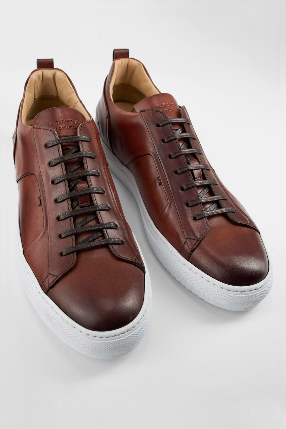 SKYE cognac folded patina sneakers.