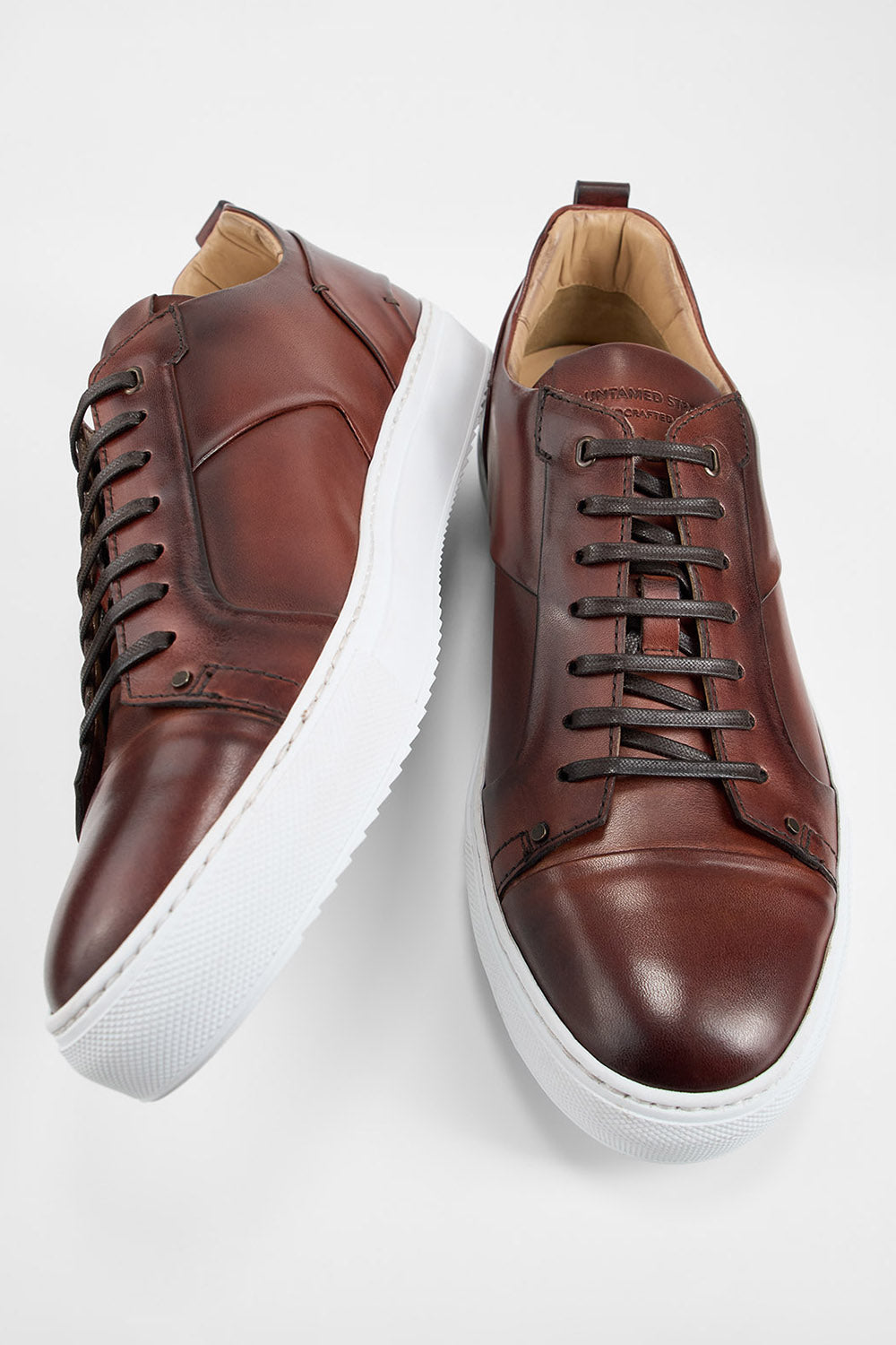 SKYE cognac studded patina sneakers.
